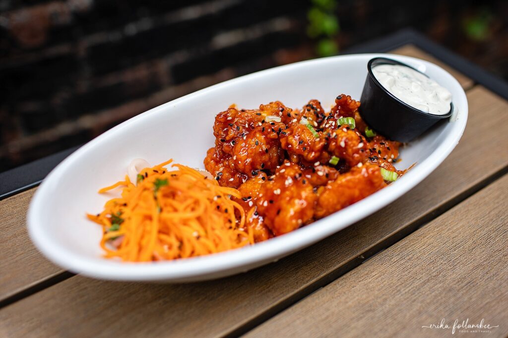 Outdoor seating in The Grotto at The Stage Restaurant in Keene NH | Korean Popcorn Chicken appetizer